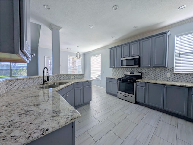 kitchen with appliances with stainless steel finishes, crown molding, a healthy amount of sunlight, and sink