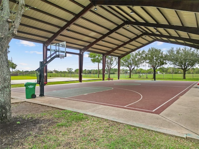 view of basketball court with a lawn