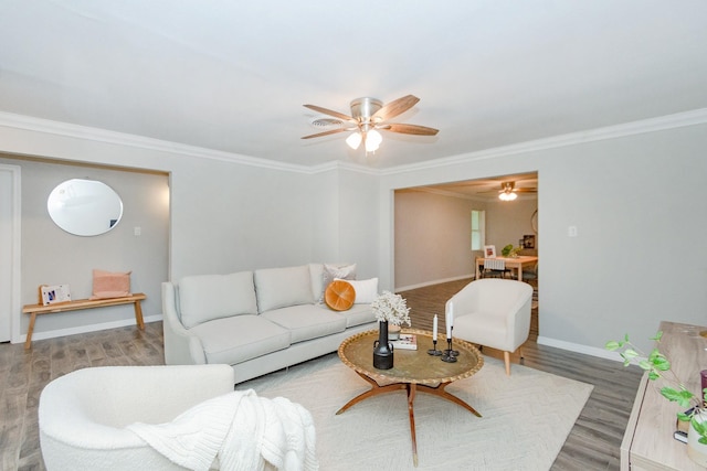 living room with wood-type flooring and ornamental molding