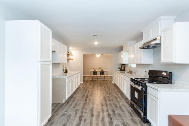 kitchen featuring white cabinets, light hardwood / wood-style floors, and black stove