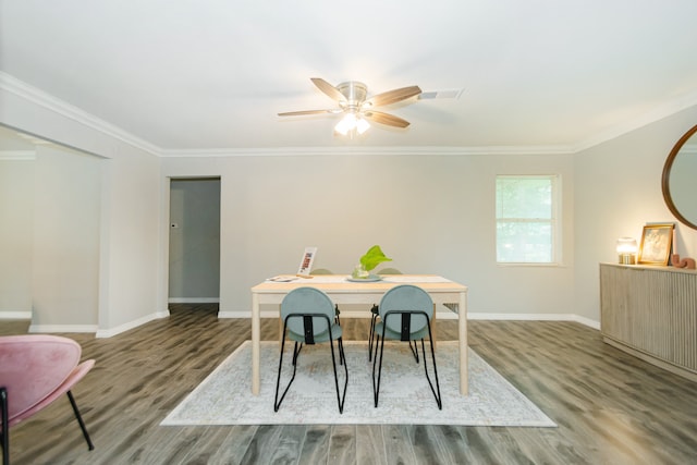 dining space featuring hardwood / wood-style flooring, ceiling fan, and crown molding