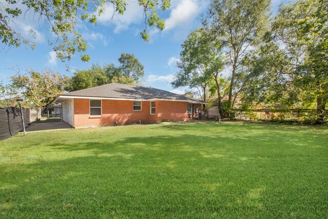 2002 Nottingham St, Pasadena, TX 77502 - view of yard with a fenced backyard and a carport
