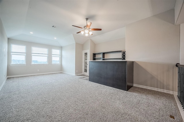 unfurnished living room featuring ceiling fan, light colored carpet, and vaulted ceiling