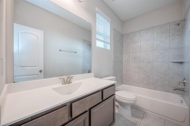 full bathroom featuring toilet, vanity, tile patterned floors, and tiled shower / bath