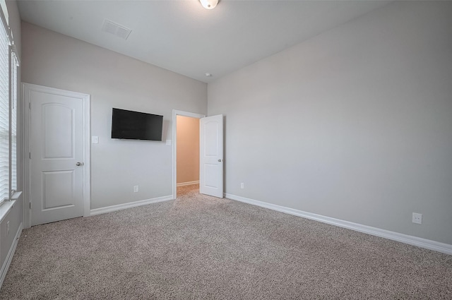 unfurnished bedroom with multiple windows and carpet floors