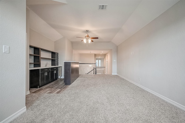 unfurnished living room with light carpet and ceiling fan