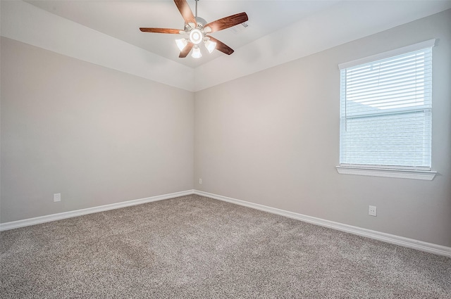 carpeted spare room featuring ceiling fan