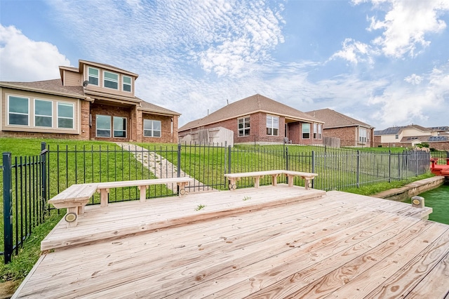 wooden deck featuring a lawn