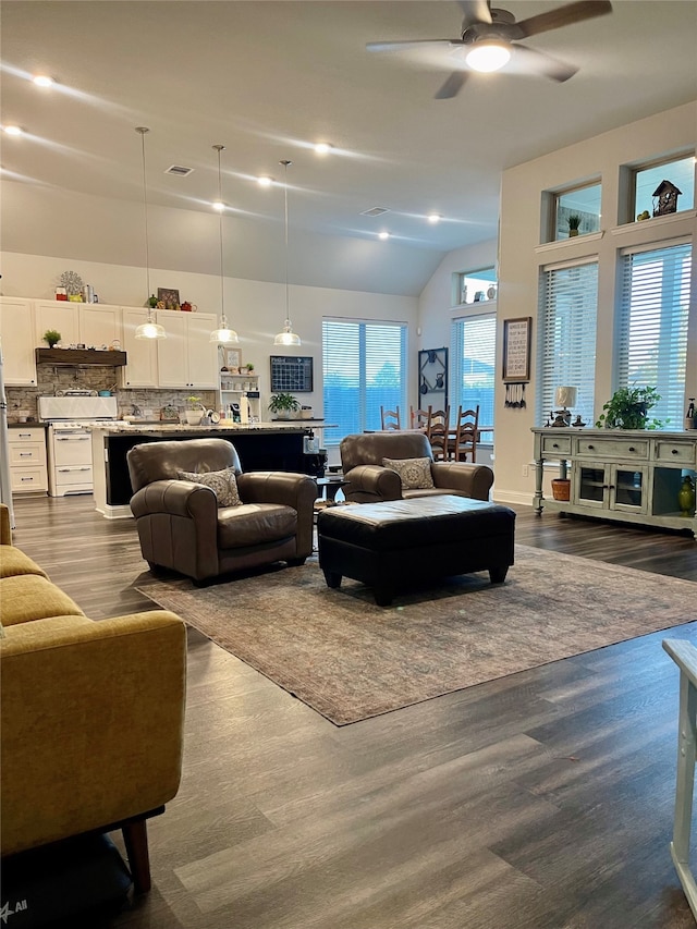 living room with wood-type flooring, high vaulted ceiling, and ceiling fan