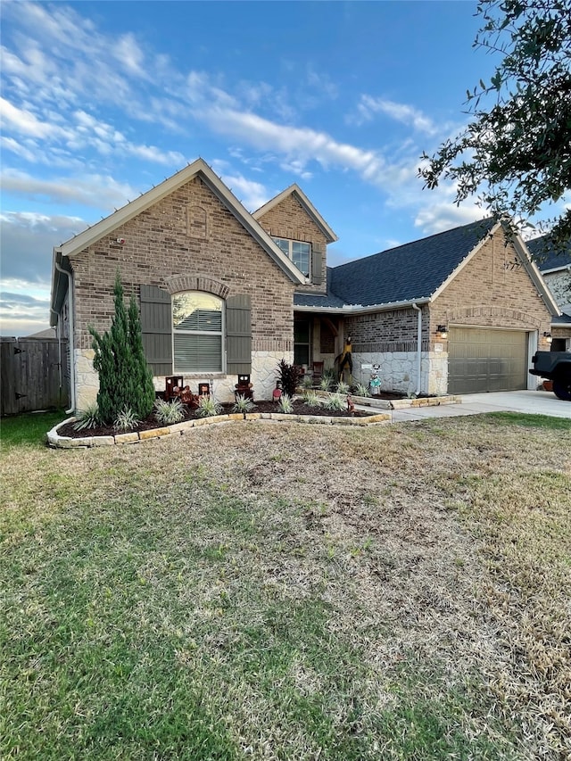 view of front of house with a garage and a front lawn