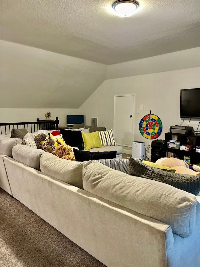 carpeted living room featuring a textured ceiling and vaulted ceiling