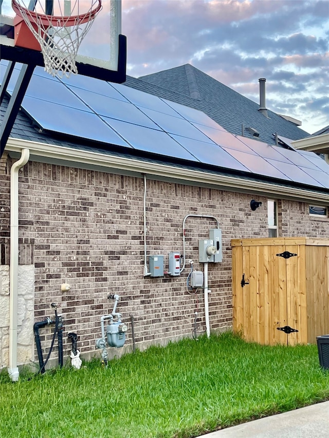 view of side of home with solar panels