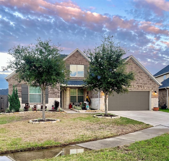 view of property hidden behind natural elements with a yard and a garage