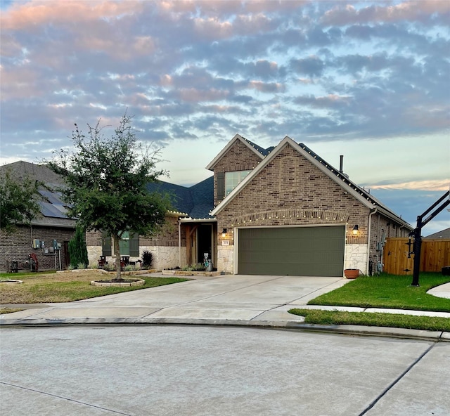 view of front of home with a lawn and a garage