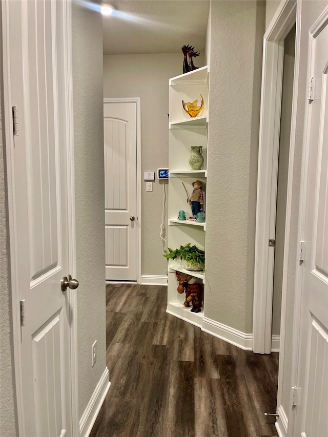 hallway with dark hardwood / wood-style floors