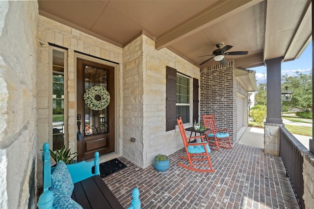 entrance to property with ceiling fan, brick siding, and a porch