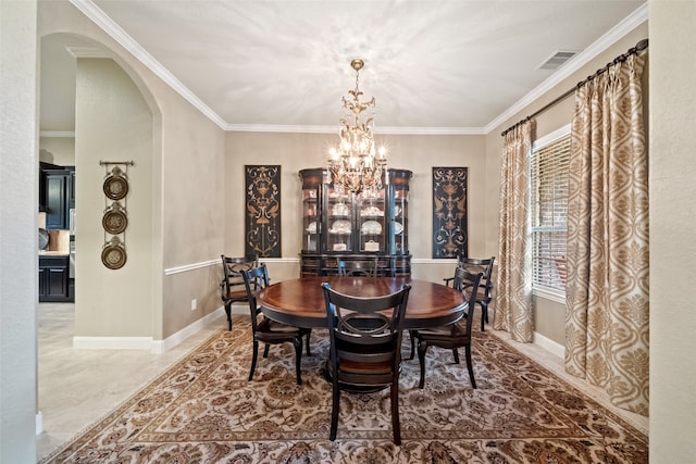 dining area featuring a notable chandelier and crown molding