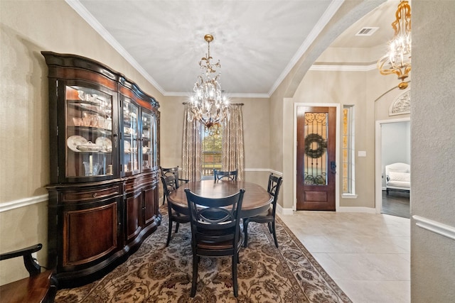 dining space with visible vents, arched walkways, ornamental molding, an inviting chandelier, and light tile patterned flooring