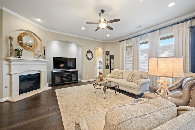 living room featuring ceiling fan, dark hardwood / wood-style floors, and crown molding