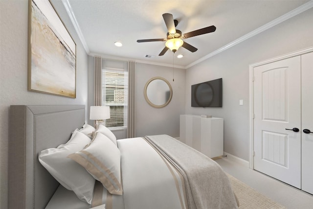 carpeted bedroom featuring a ceiling fan, baseboards, visible vents, a closet, and crown molding