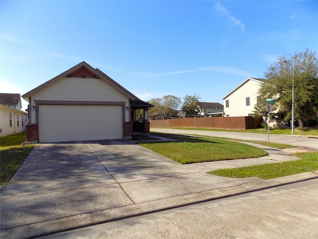 view of front of property with a front yard and a garage