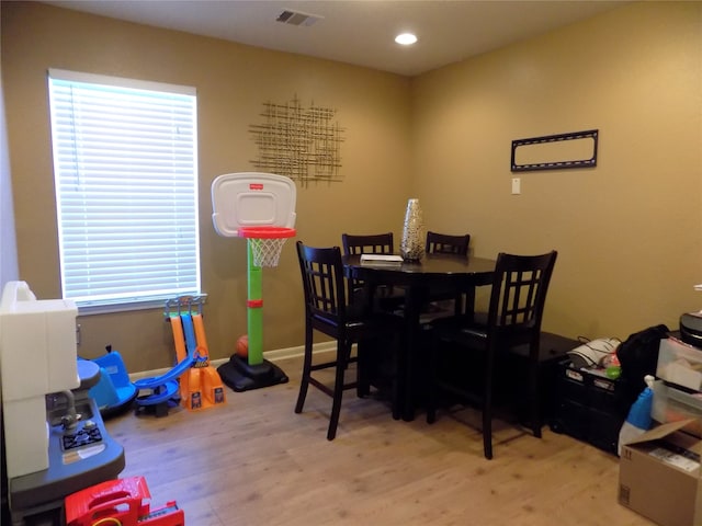 dining space with light hardwood / wood-style floors