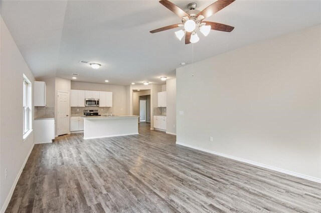 unfurnished living room featuring light wood-type flooring and ceiling fan