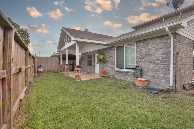 rear view of property with a patio area and a yard