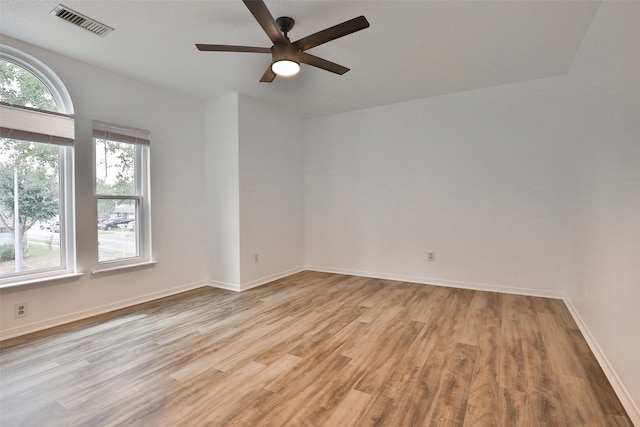 empty room with ceiling fan and light wood-type flooring