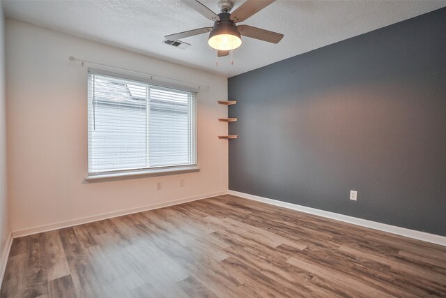 unfurnished room with wood-type flooring, ceiling fan, and a textured ceiling