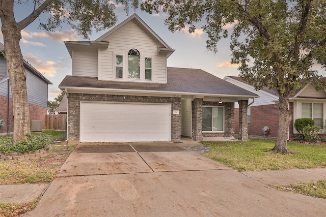 view of front of home with a garage and central AC