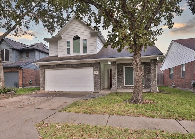 view of front of home featuring a garage and a yard