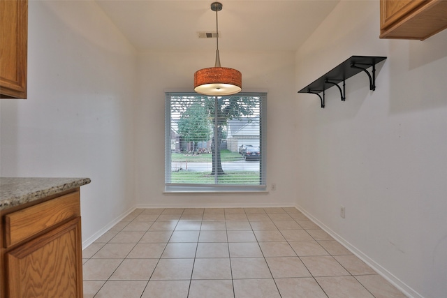 unfurnished dining area featuring light tile patterned floors