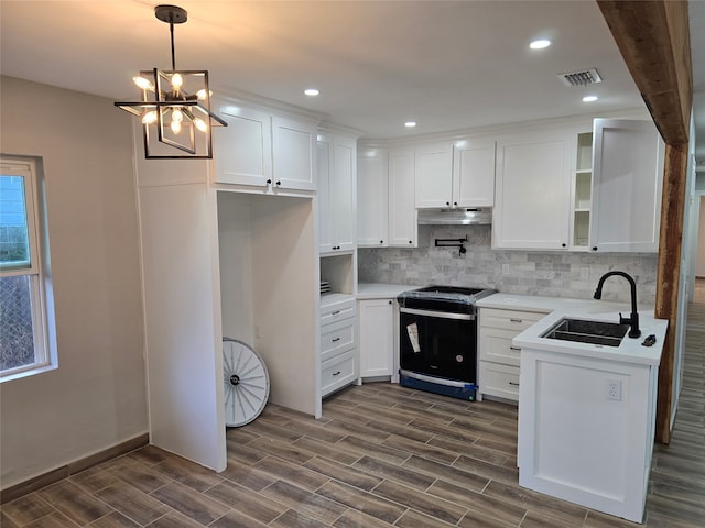 kitchen featuring white cabinetry, range, dark hardwood / wood-style floors, sink, and a chandelier