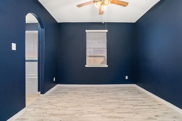 spare room with light wood-type flooring and ceiling fan