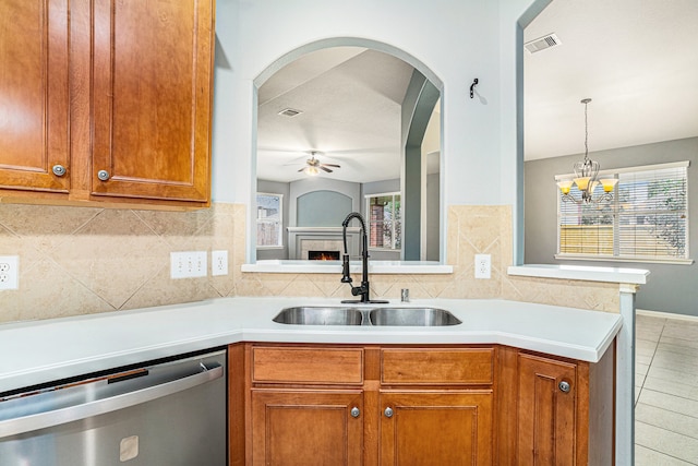 kitchen featuring dishwasher, sink, backsplash, kitchen peninsula, and ceiling fan with notable chandelier