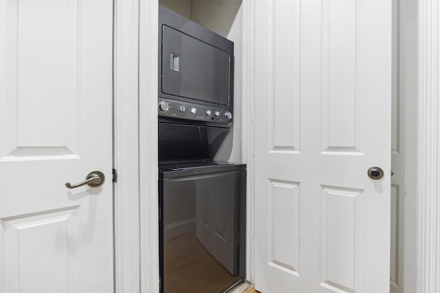 laundry room with stacked washer / drying machine