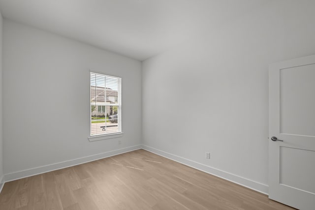 empty room featuring light wood-style flooring and baseboards