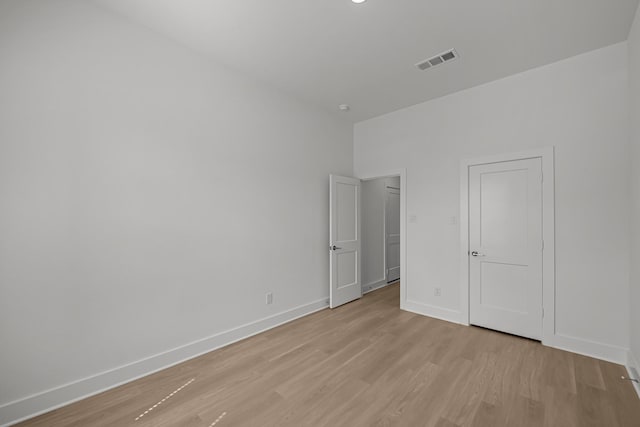 unfurnished bedroom featuring visible vents, baseboards, and light wood-style floors