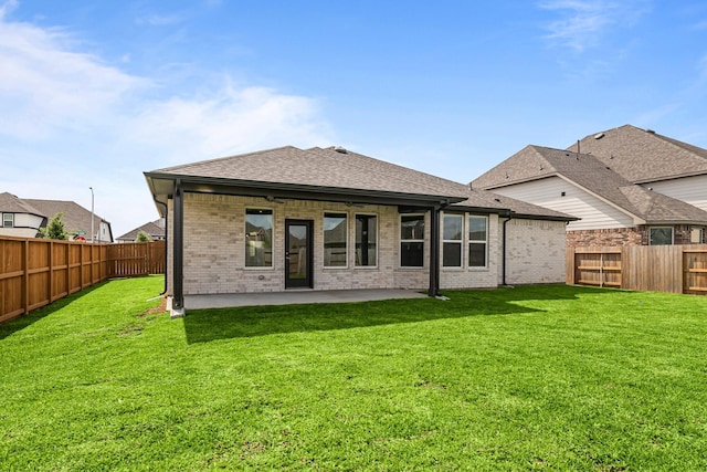 back of house with a patio area, a lawn, a ceiling fan, brick siding, and a fenced backyard