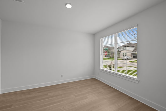 unfurnished room featuring baseboards and light wood-style flooring