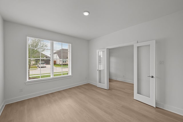 unfurnished bedroom featuring light wood-style flooring and baseboards