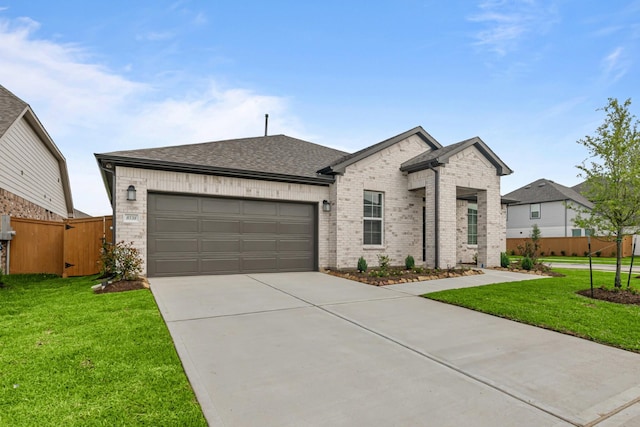view of front of property featuring a front yard, a garage, brick siding, concrete driveway, and fence