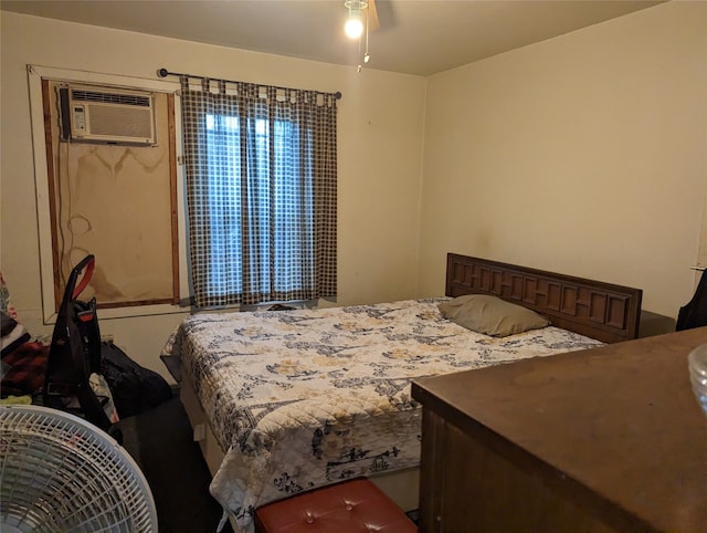 bedroom with a wall unit AC and ceiling fan