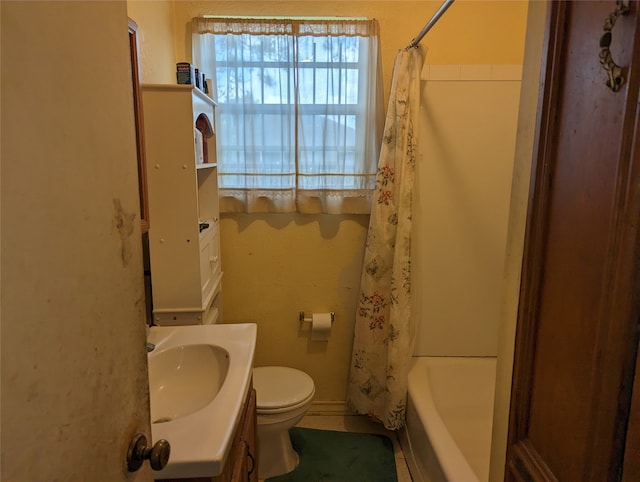 full bathroom featuring toilet, vanity, and shower / bathtub combination with curtain