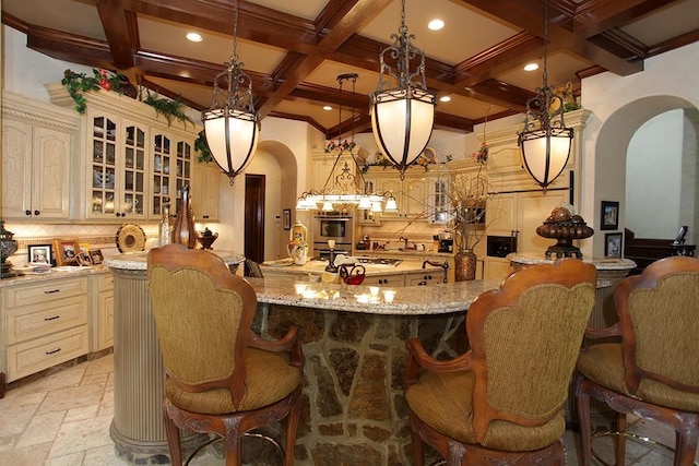 bar featuring tasteful backsplash, decorative light fixtures, stainless steel oven, and light stone countertops