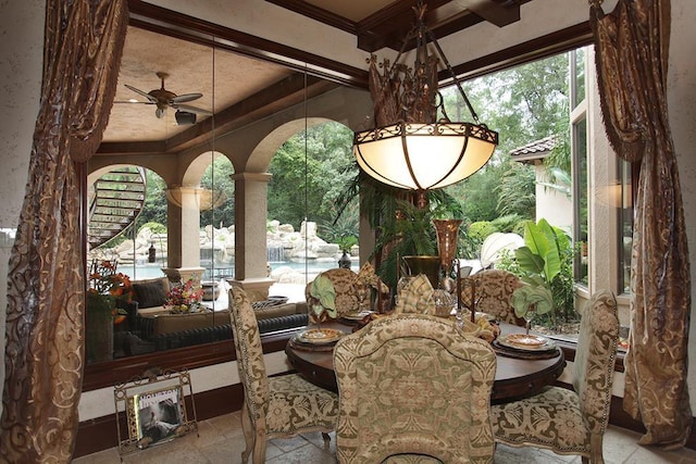 23 Villeroy Way, The Woodlands, TX 77382 - dining room featuring stone tile floors, healthy amount of natural light, ornate columns, ceiling fan, and beamed ceiling