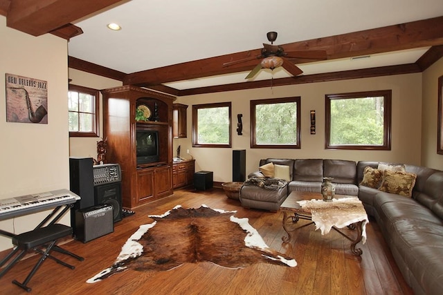 living room with beamed ceiling, wood-type flooring, and plenty of natural light