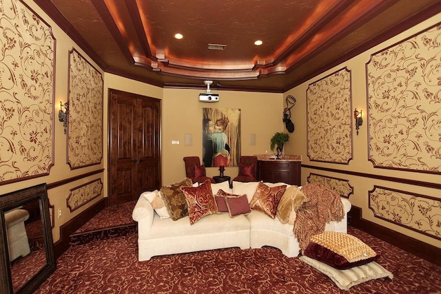 carpeted home theater room featuring a tray ceiling