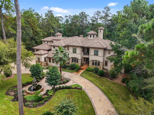 mediterranean / spanish home with a front yard